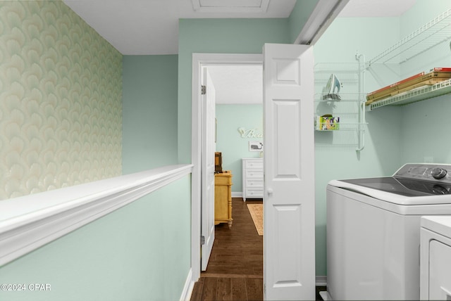 laundry room with dark wood-type flooring and washer and dryer