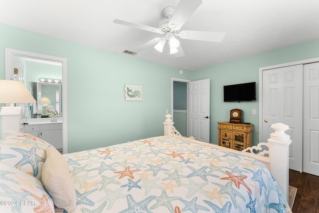 bedroom featuring dark wood-type flooring, ceiling fan, a closet, and ensuite bathroom