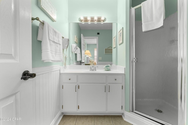 bathroom featuring vanity, an enclosed shower, and tile patterned flooring