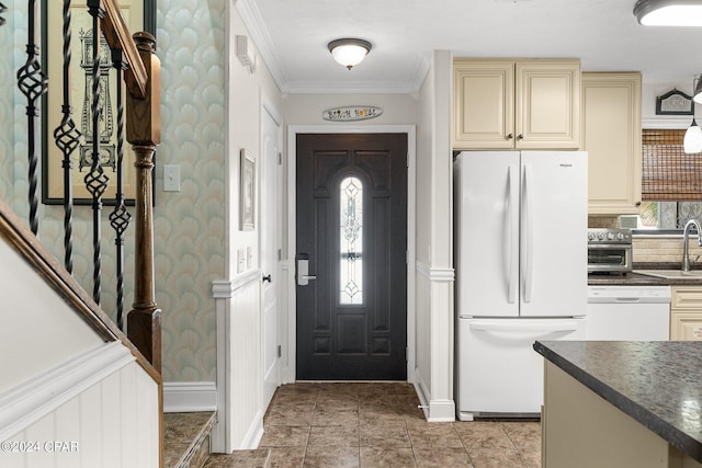 entryway with ornamental molding and sink