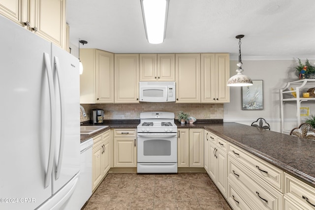 kitchen featuring white appliances, cream cabinets, sink, hanging light fixtures, and decorative backsplash