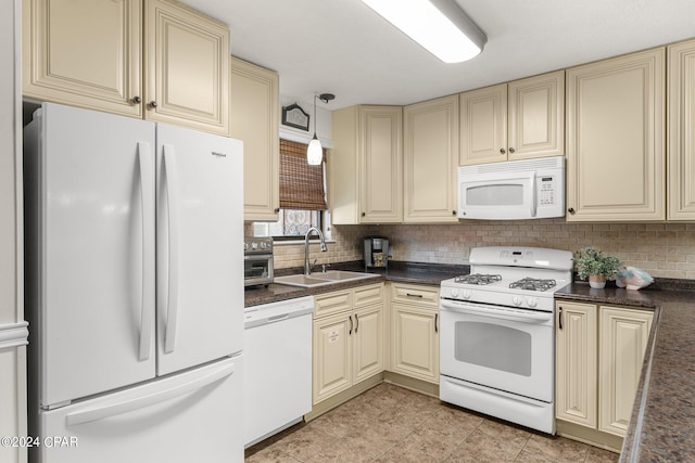 kitchen with white appliances, tasteful backsplash, sink, and pendant lighting