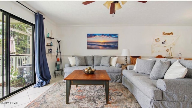 living room featuring crown molding, light tile patterned floors, and ceiling fan