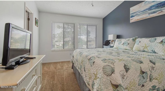 carpeted bedroom featuring a textured ceiling