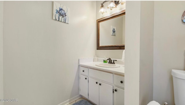 bathroom featuring vanity and toilet