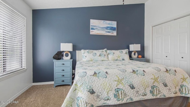 bedroom with light carpet and a closet