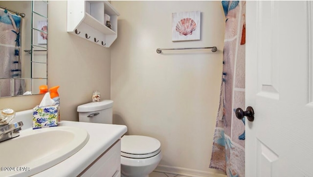 bathroom with vanity, tile patterned flooring, and toilet