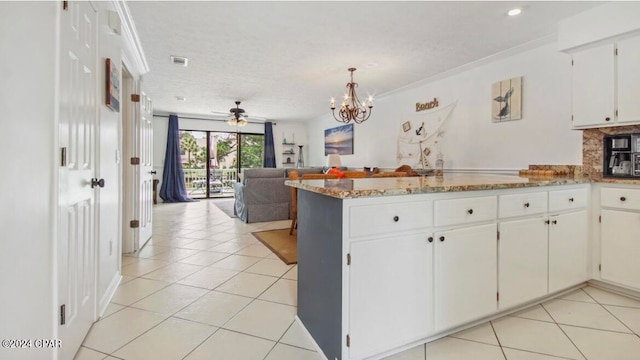 kitchen with ornamental molding, kitchen peninsula, white cabinetry, and light tile patterned floors