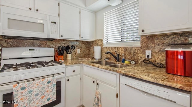 kitchen featuring tasteful backsplash, white appliances, sink, and white cabinets