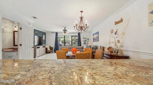 tiled dining area with ceiling fan with notable chandelier and ornamental molding