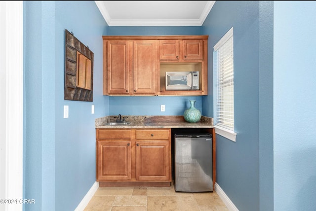 kitchen with ornamental molding, dishwasher, and sink