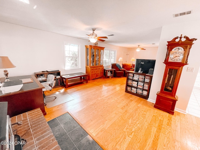 living room featuring hardwood / wood-style floors and ceiling fan