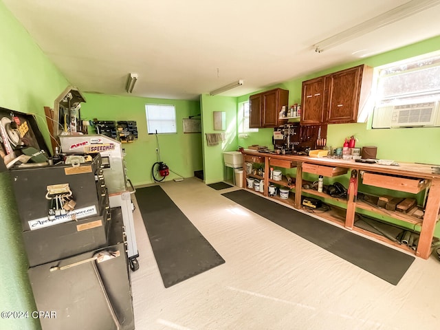 exercise room with carpet flooring, a workshop area, and cooling unit