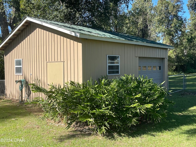 exterior space featuring a yard and a garage