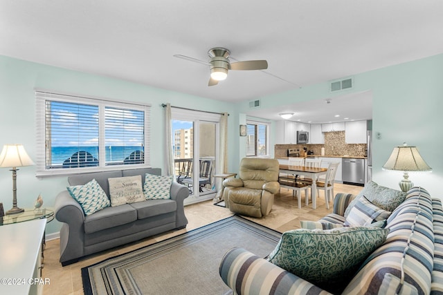 tiled living room featuring ceiling fan