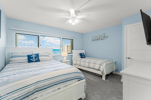 carpeted bedroom featuring ceiling fan, a textured ceiling, and multiple windows