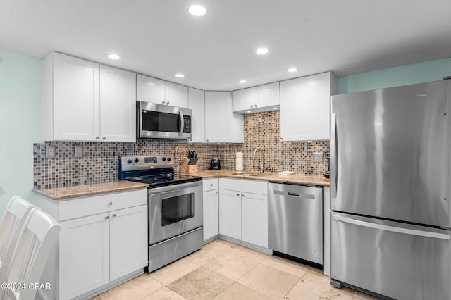 kitchen featuring white cabinets, stainless steel appliances, and sink