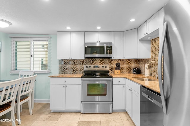 kitchen with white cabinetry, sink, and stainless steel appliances