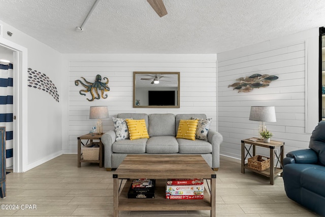 living room featuring a textured ceiling and light wood-type flooring