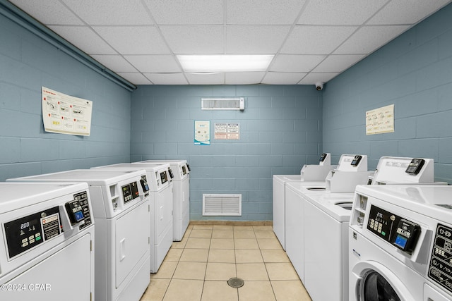 laundry area featuring washer and dryer and light tile patterned floors