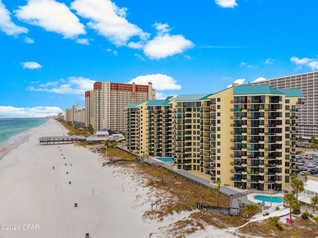 view of property featuring a water view and a view of the beach