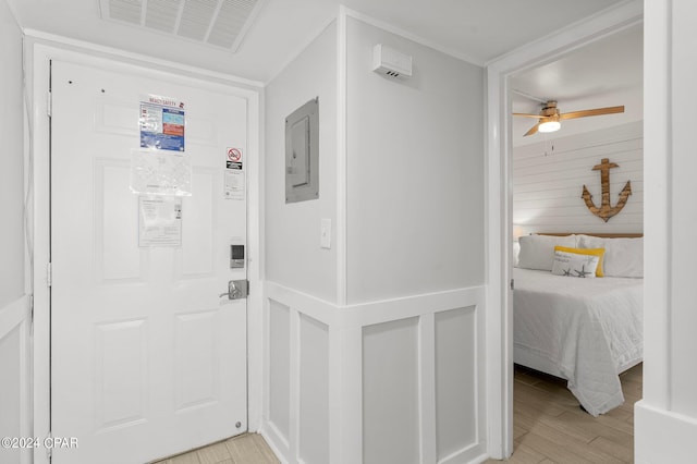 hallway featuring electric panel and light wood-type flooring