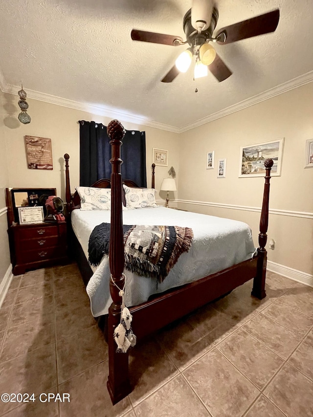 bedroom with ceiling fan, tile patterned flooring, a textured ceiling, and ornamental molding