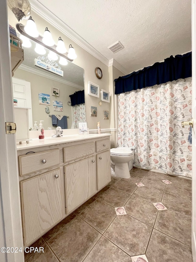 bathroom with tile patterned floors, crown molding, a textured ceiling, toilet, and vanity