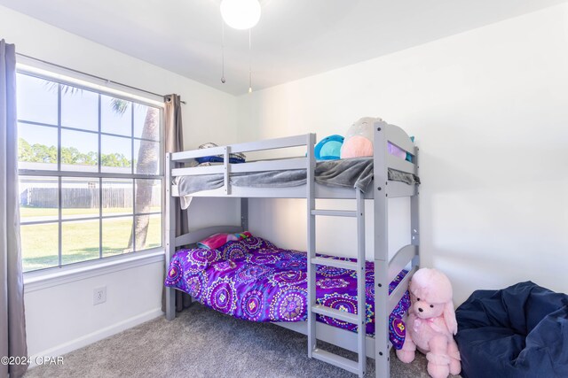 bedroom with multiple windows and carpet flooring