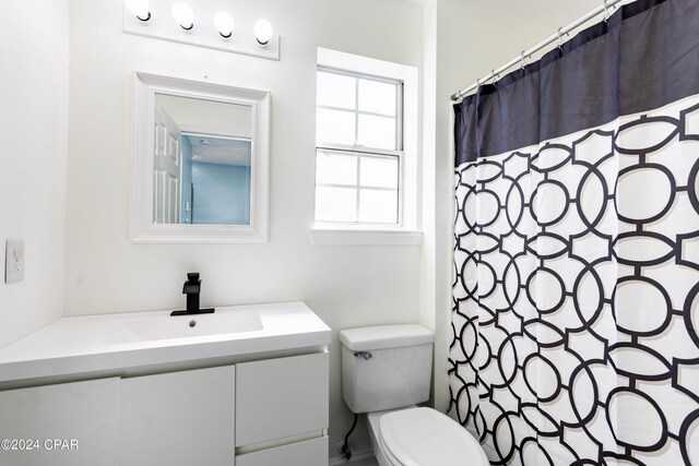 bathroom with vanity, toilet, and a shower with shower curtain