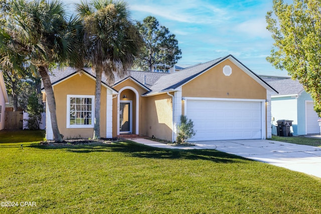 ranch-style home featuring a front lawn and a garage