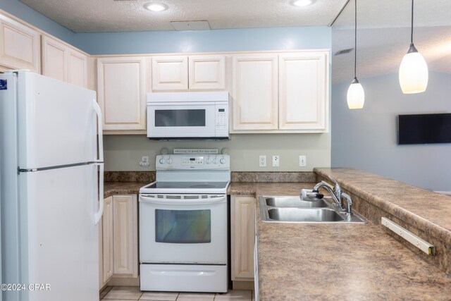 kitchen featuring light tile patterned floors, a textured ceiling, sink, decorative light fixtures, and white appliances