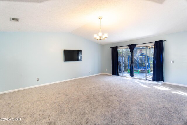 unfurnished room with vaulted ceiling and carpet floors