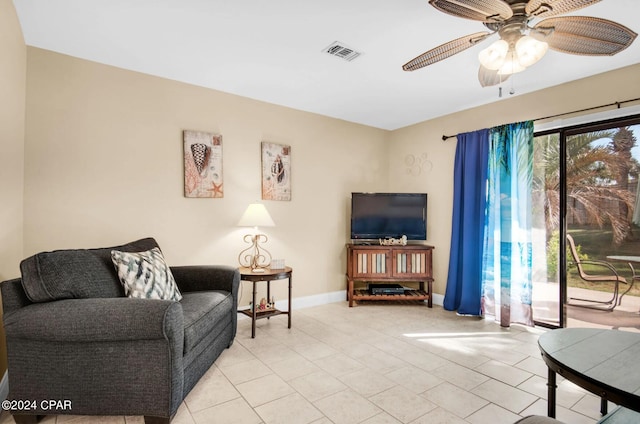 tiled living room featuring ceiling fan