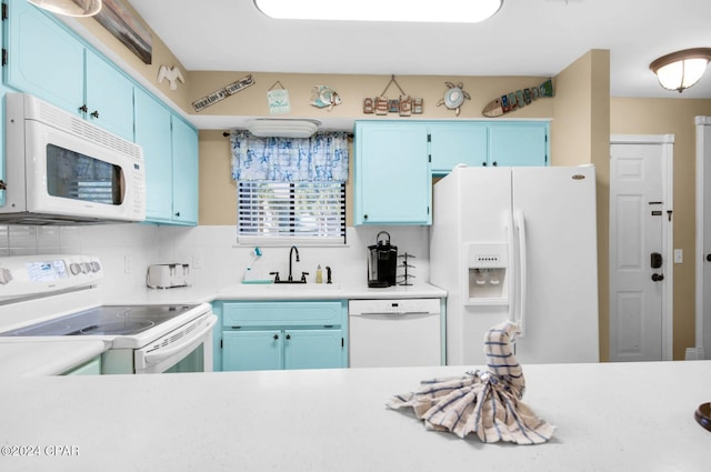 kitchen featuring white appliances, sink, and blue cabinets