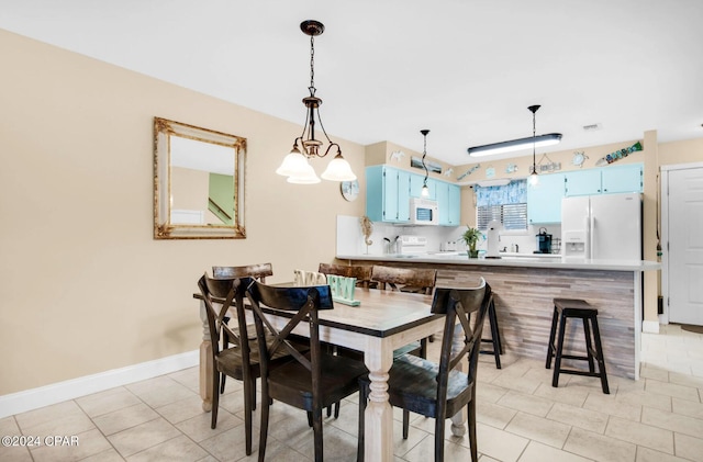 dining space featuring light tile patterned floors