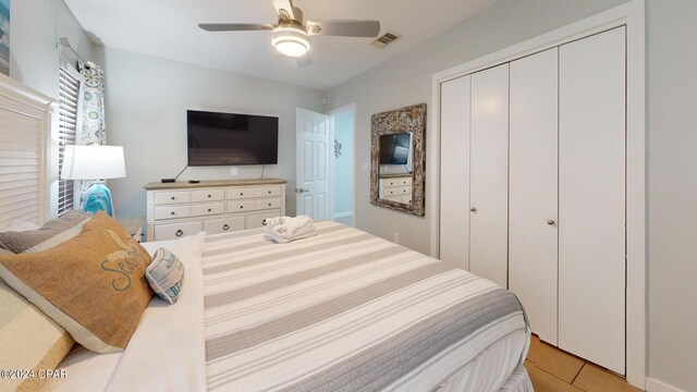 tiled bedroom with a closet and ceiling fan