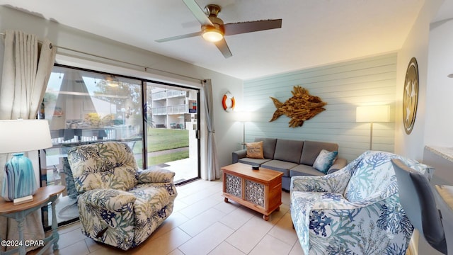 living room with wooden walls and ceiling fan