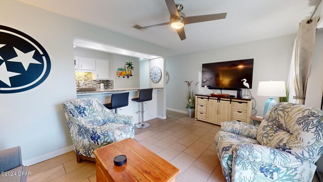 living room with light tile patterned floors and ceiling fan