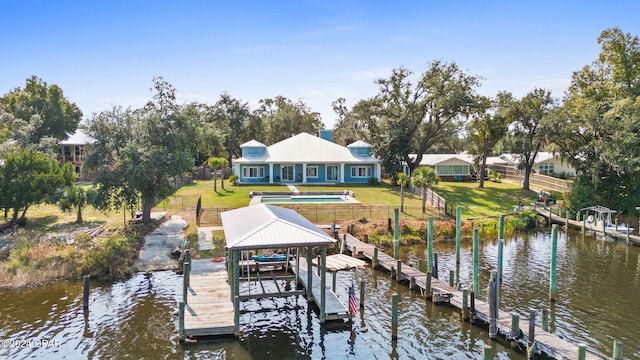 dock area featuring a water view and a lawn