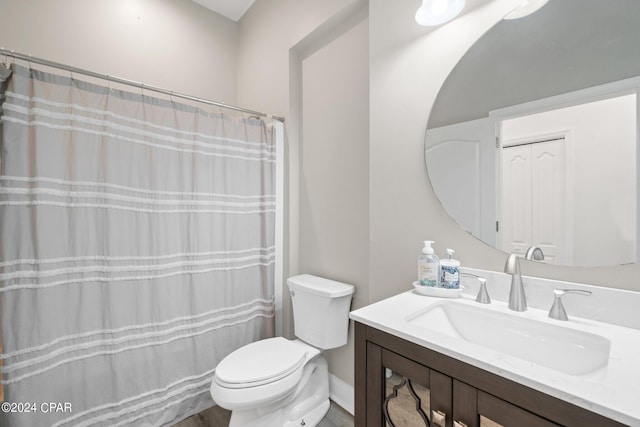 bathroom featuring vanity, toilet, and a shower with shower curtain