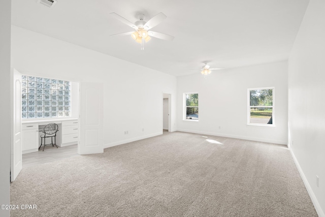 empty room with ceiling fan and light colored carpet