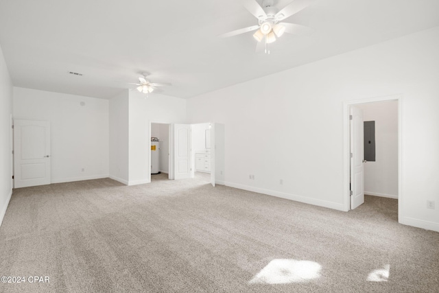 interior space featuring gas water heater, electric panel, light colored carpet, and ceiling fan