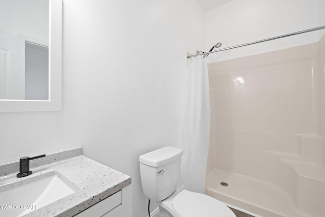 bathroom featuring toilet, a shower with curtain, and vanity