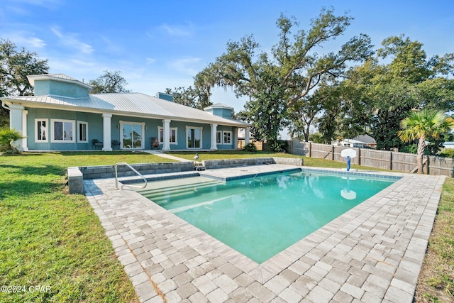 view of swimming pool featuring a yard