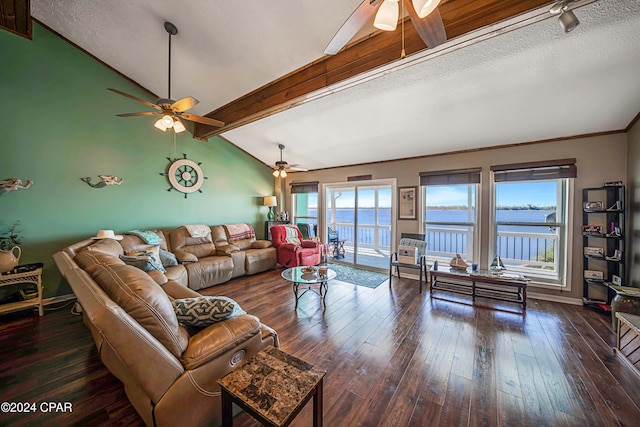 living room with vaulted ceiling with beams, a textured ceiling, ceiling fan, a water view, and dark hardwood / wood-style floors