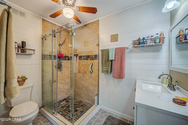 full bathroom featuring toilet, wood walls, a shower stall, and vanity