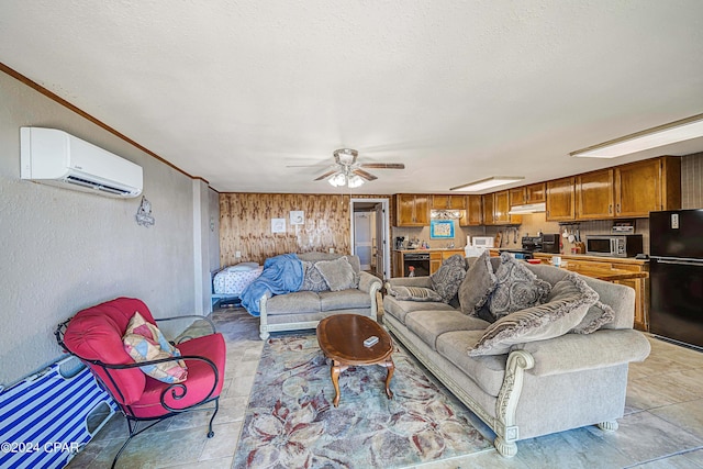 living room with a textured wall, a wall mounted air conditioner, ceiling fan, and a textured ceiling