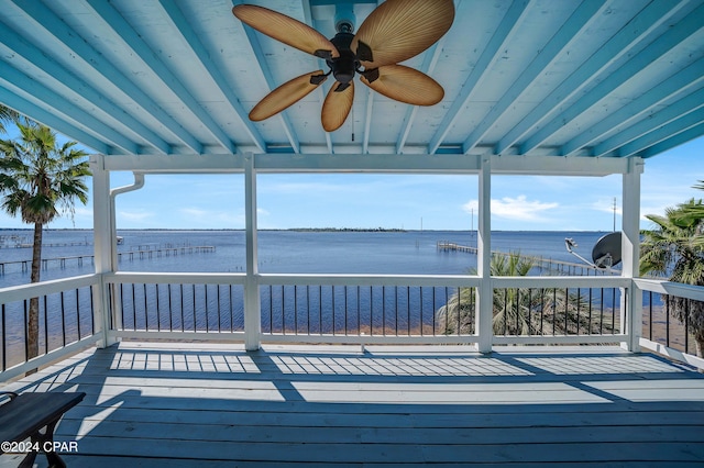 deck with a water view and a ceiling fan