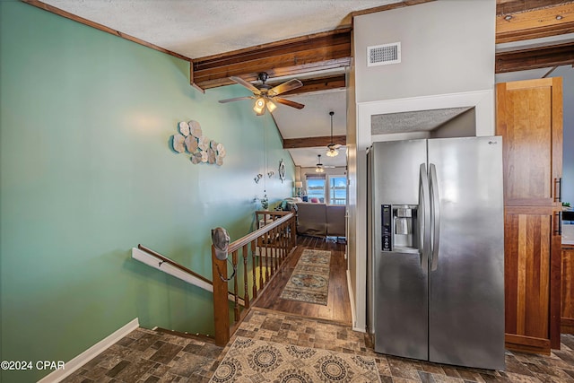 kitchen featuring beamed ceiling, stainless steel fridge with ice dispenser, and a textured ceiling